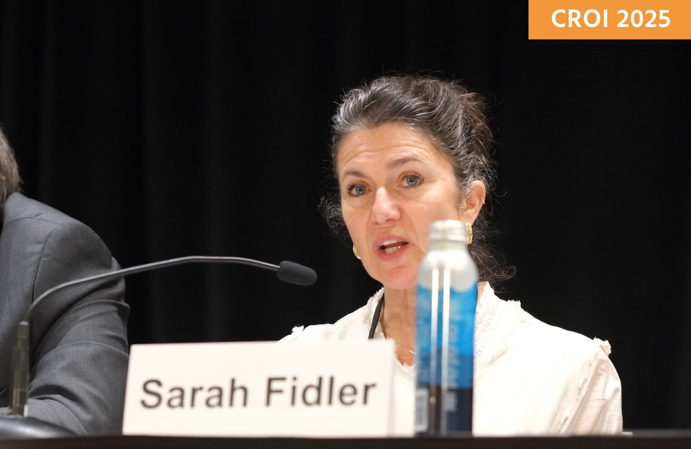 Professor Sarah Fidler at a media briefing at CROI 2025. She is talking into a microphone.