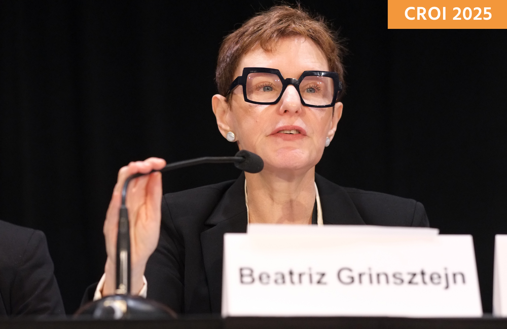 Dr Beatriz Grinsztejn at a media briefing at CROI 2025. She is talking into a microphone.