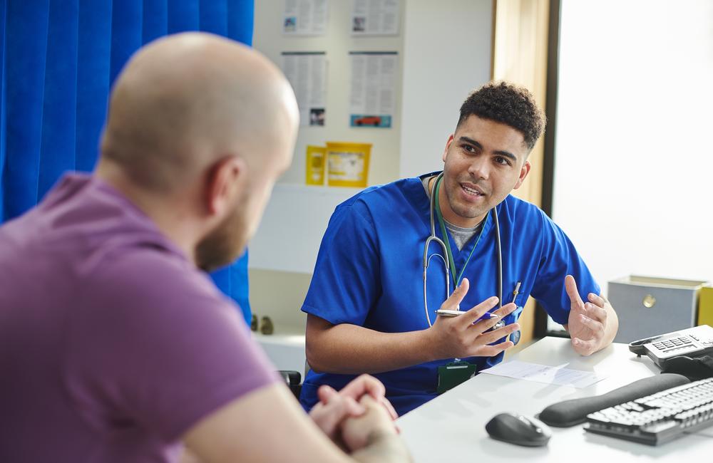 A medical professional speaking to a patient.